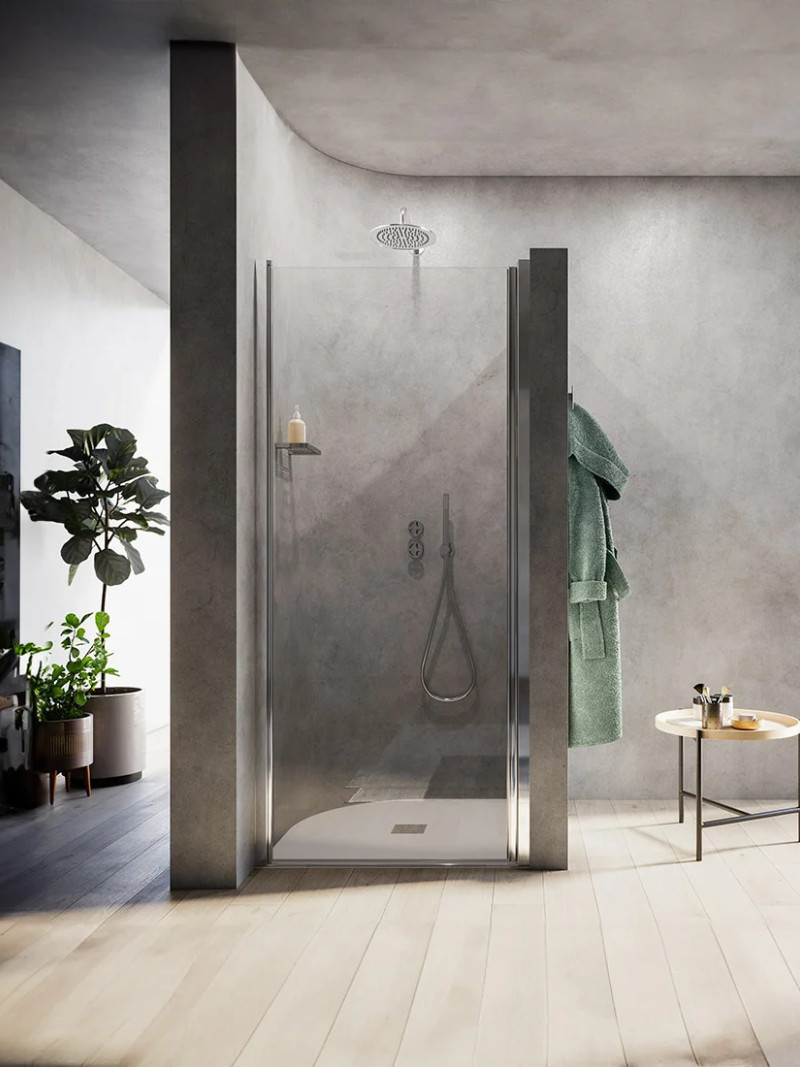A walk-in shower with a fixed glass screen in a contemporary bathroom decorated in shades of grey.