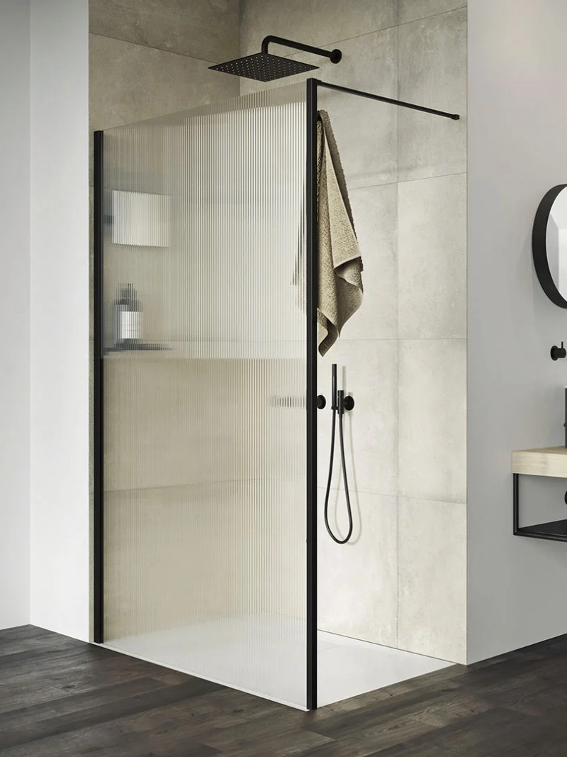 Modern walk-in shower with a black frame, featuring an extra-shallow shower tray and black taps.