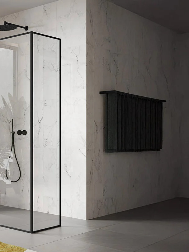 Glass shower enclosure with black frames in a modern bathroom