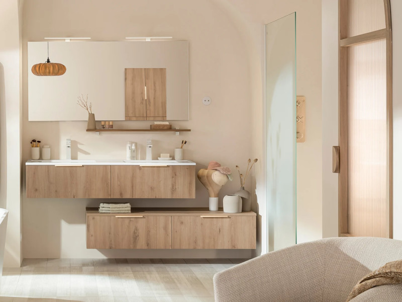 A modern family bathroom with twin washbasins, a glass-enclosed walk-in shower, a bath and light-coloured wooden storage units.